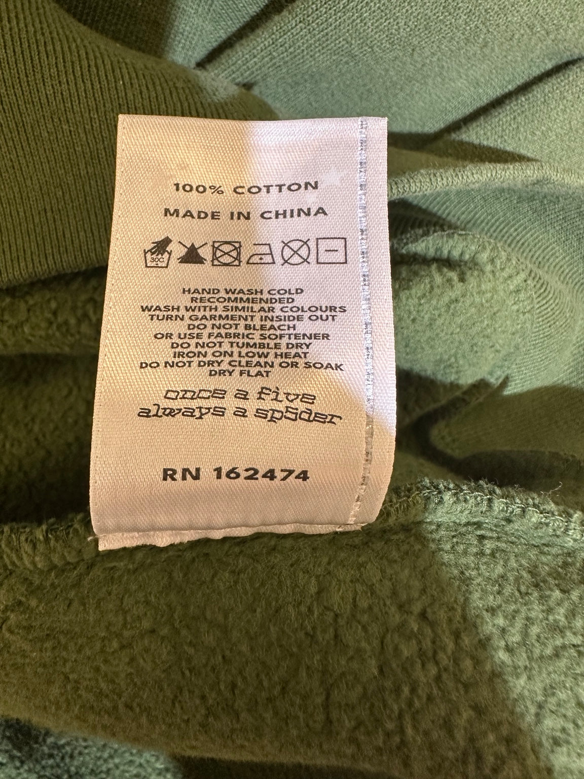 Sp5der Forest Green TM Crewneck care tag