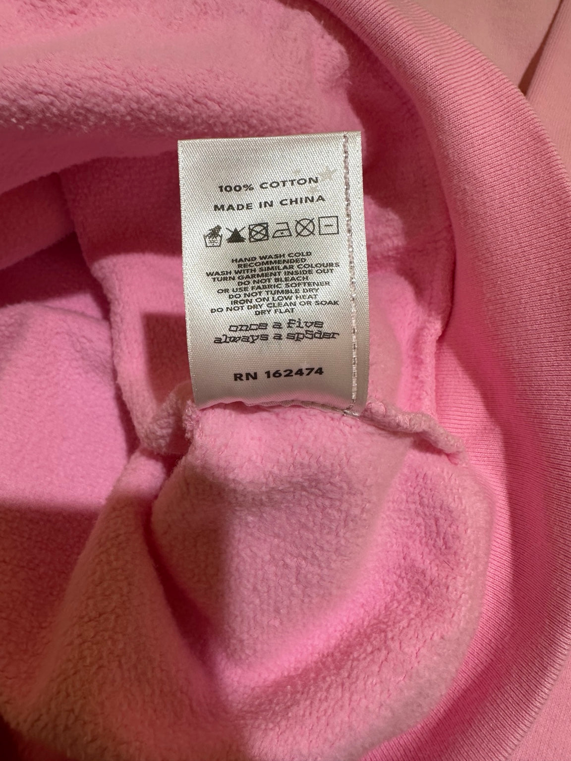 Sp5der Pink OG Web Rhinestone Zip Up care tag